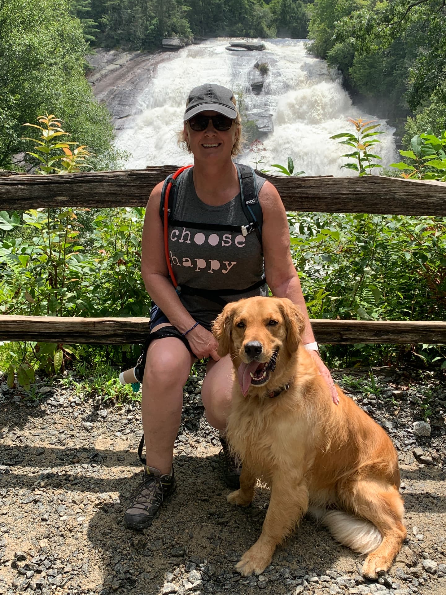 Karen and her golden retriever resting in front of High Falls