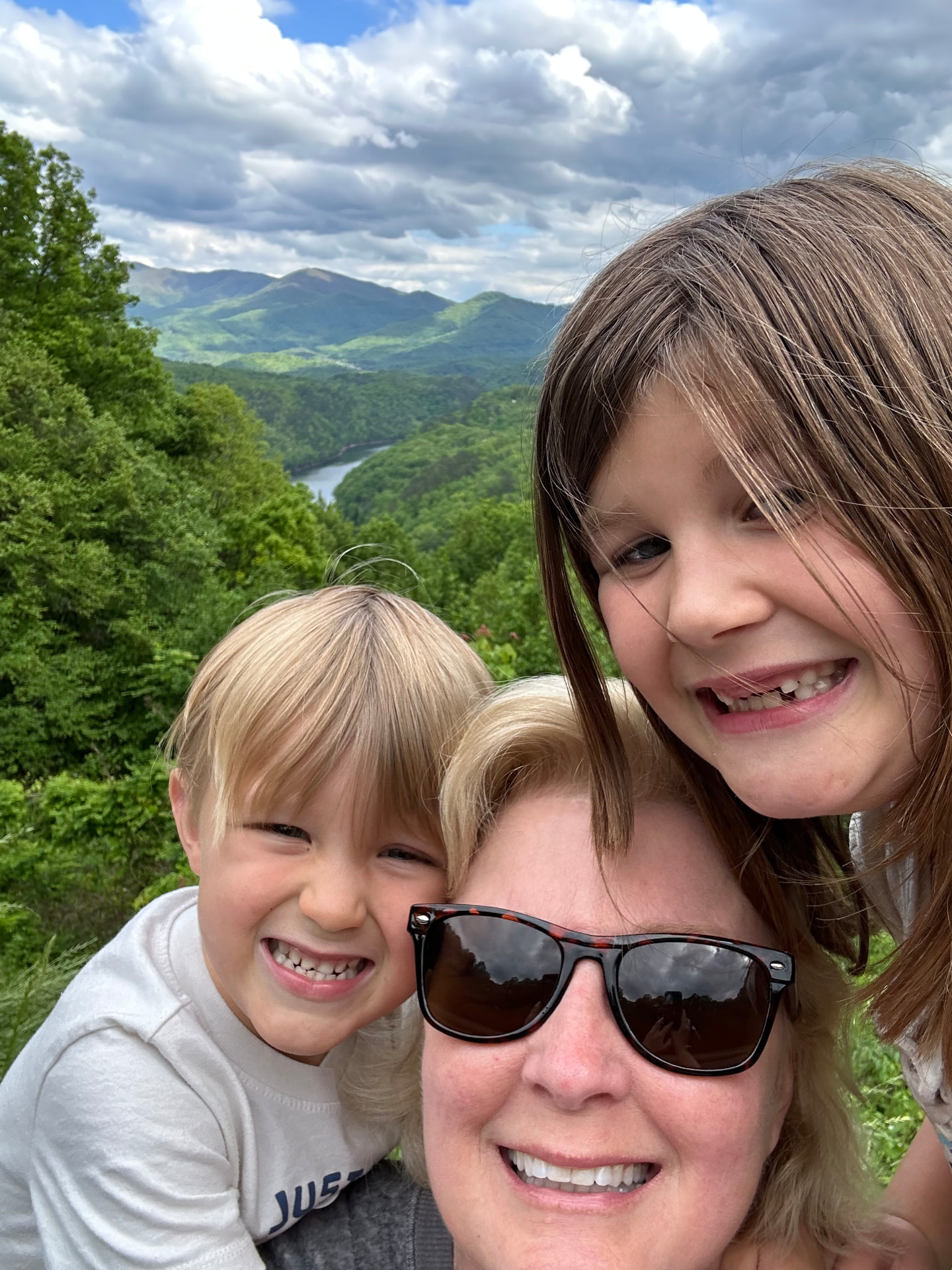 Karen with two young children outdoors with mountains in the background